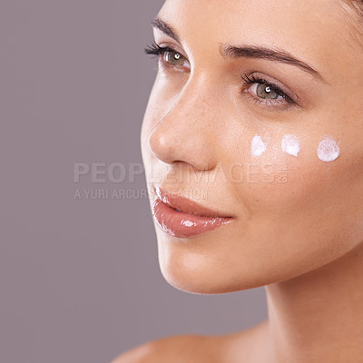 Buy stock photo Face, cream and thinking of skincare with woman in studio, moisturizer and dermatology for wellness on purple background. Skin health, cosmetic product with sunscreen or lotion dots, facial or mask