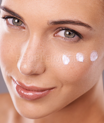Buy stock photo Face, cream and skincare with woman in portrait in studio, moisturizer and dermatology for beauty. Skin health, cosmetic product with sunscreen or lotion dots, facial treatment or salon for antiaging