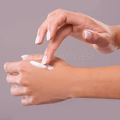 Buy stock photo Hands, cream and beauty with woman for skincare, dermatology and wellness on grey background. Moisturizer, lotion or sunscreen with nails and manicure, antiaging cosmetic product and skin health