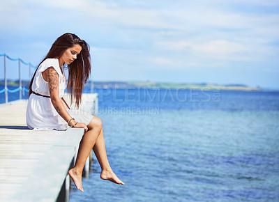 Buy stock photo Woman, sitting and ocean on pier in summer with thinking, memory and relax on vacation with mockup space. Girl, person and idea by waves, sea or water by bridge, promenade or dock on holiday in Italy