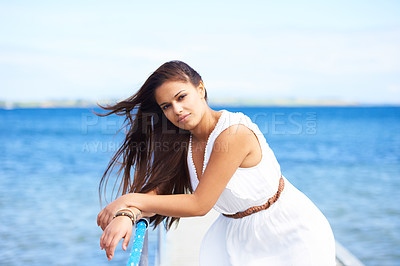 Buy stock photo Woman, portrait and ocean on pier in summer with fashion, dress or confidence on vacation in sunshine. Girl, person and outdoor by waves, sea or water by bridge, promenade or dock on holiday in Italy