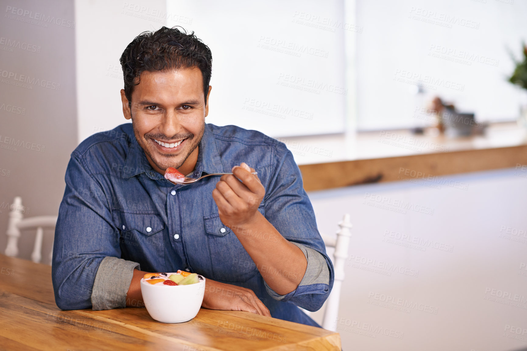 Buy stock photo Portrait, smile and man eating fruit salad in home at table for healthy diet, nutrition or wellness at breakfast in the morning. Face, happy person and hungry for food, yogurt or organic strawberry
