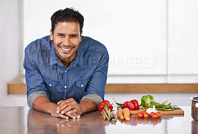 Buy stock photo Man, smile and vegetables in kitchen for food, cooking and recipe for health indoor on mockup. Nutritionist or vegan  with carrot, pepper and tomatoes with garlic for ingredient and vitamin