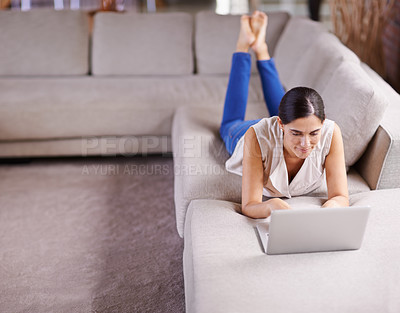 Buy stock photo Laptop, relax and social media with woman on sofa in living room of apartment for research or browsing. Computer, internet and technology with person typing email, report or article for online blog