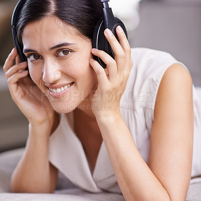Buy stock photo Happy woman, face and headphones listening to music with smile on sofa for free time, comfort or relaxing at home. Portrait of female smiling on living room couch with headset for audio sound track