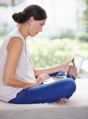 Buy stock photo Laptop, relax and woman on sofa working on creative freelance project at modern apartment. Technology, research and young female person reading information on internet with computer in living room.