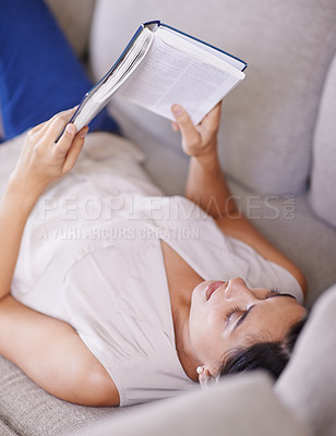 Buy stock photo Woman, hobby and relax on sofa with book, reading and learning with story and literature entertainment at home. Happy, female person in living room with fiction or novel on couch for leisure