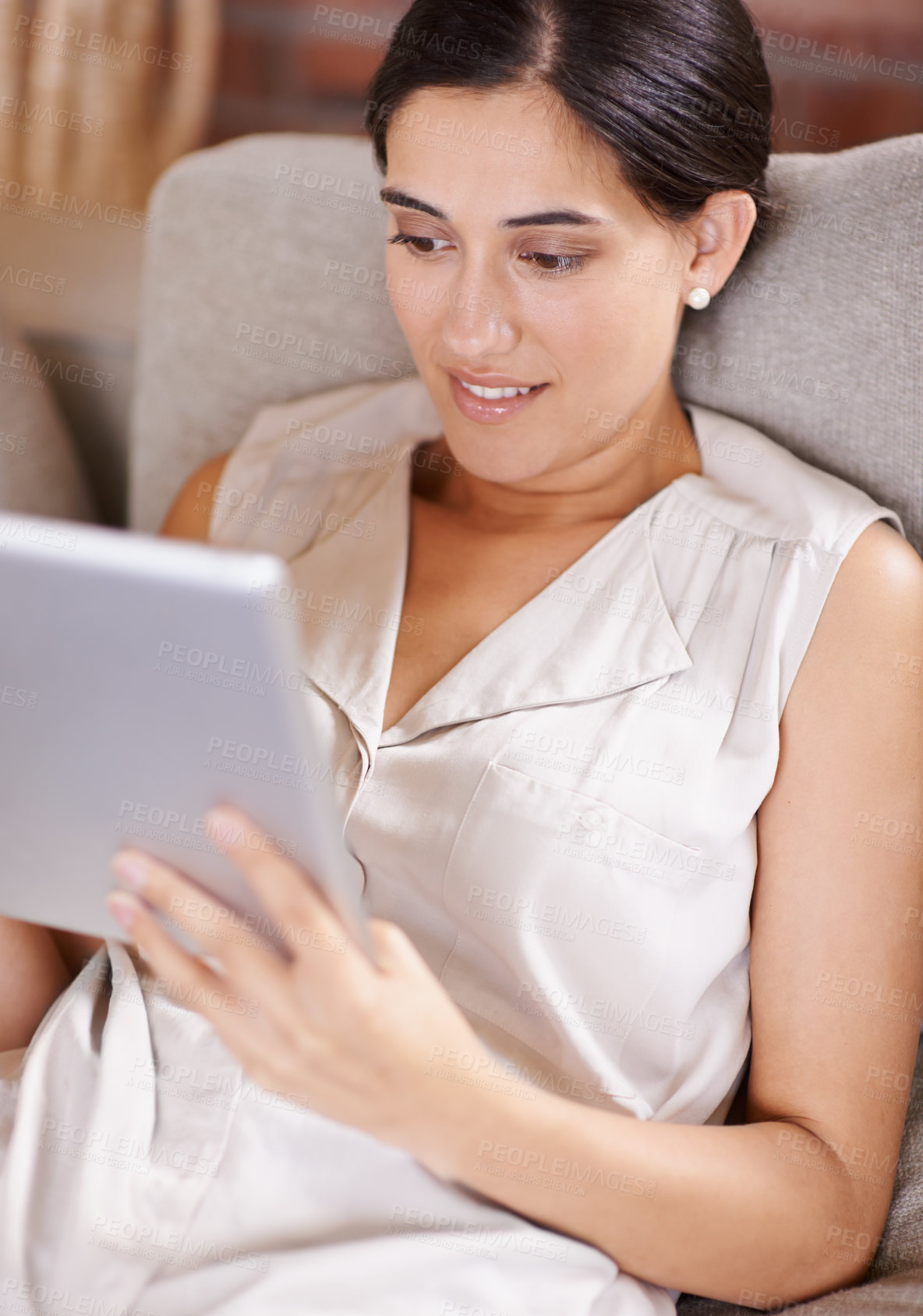 Buy stock photo Happy woman, tablet and browsing on living room sofa for streaming or social media at home. Female relaxing with smile using technology for online entertainment, app or research lying on lounge couch