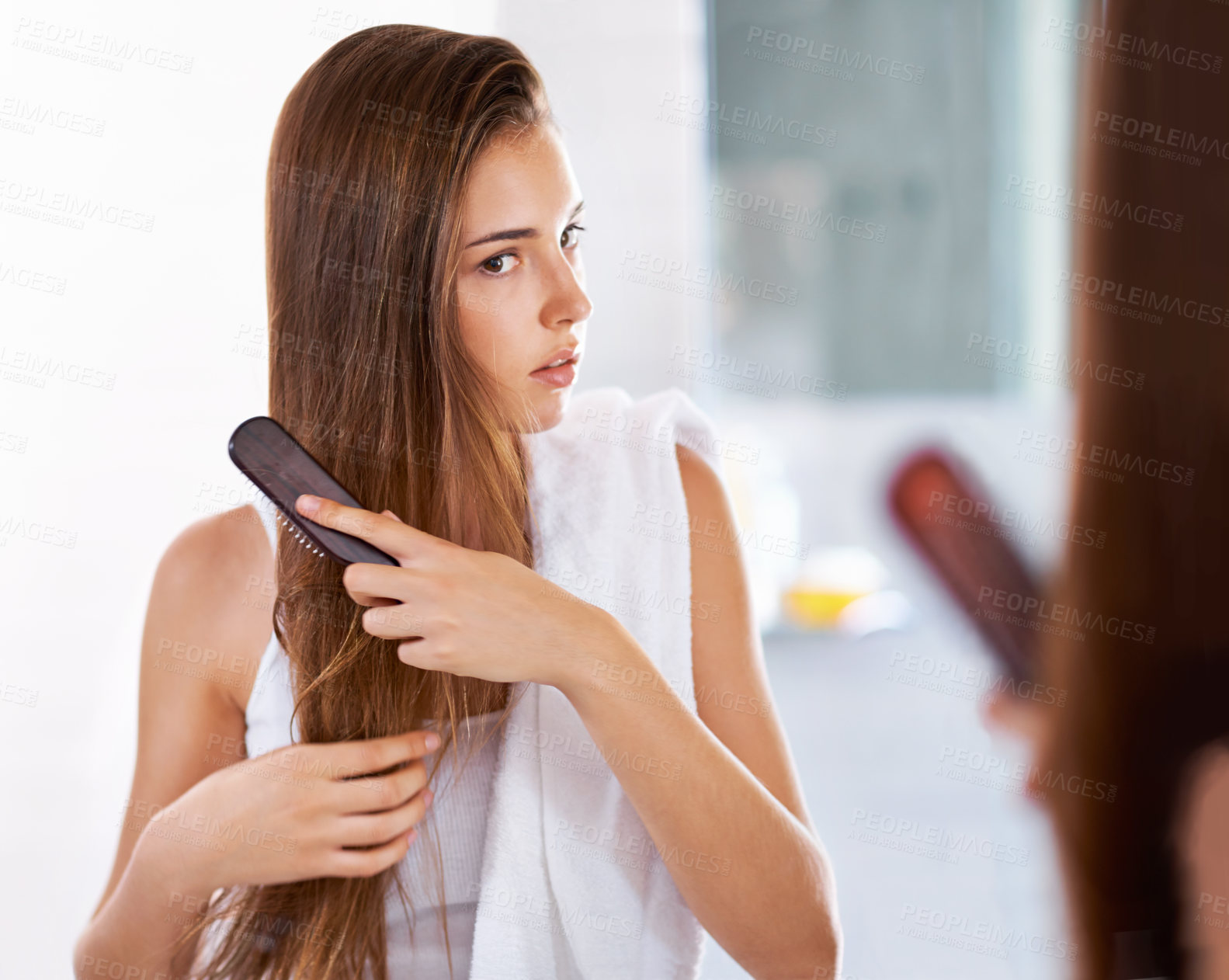 Buy stock photo Reflection, woman and brush hair in bathroom at home for beauty, care or morning routine with cosmetics. Mirror, hairstyle and serious person combing for cleaning, grooming or treatment for wellness