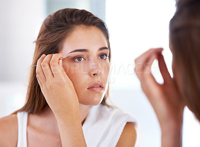 Buy stock photo Woman, mirror and eyebrows with tweezers for beauty routine in bathroom for skincare, maintenance or cosmetic. Female person, hand and tool with morning reflection for hair removal, treatment or care