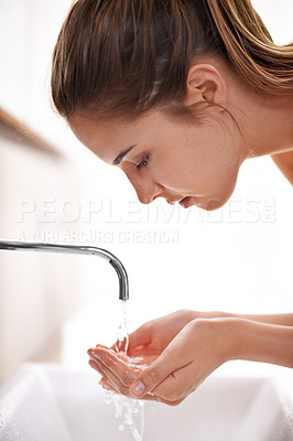 Buy stock photo Woman, house and hygeine for washing face, skincare and sink in self care and beauty with smile in restroom. Female person, clean water and tap in bathroom, morning and happy for health at home 