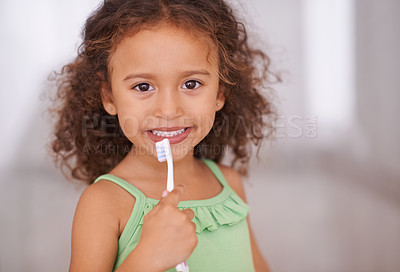 Buy stock photo Portrait of an adorable little girl holding a toothbrush