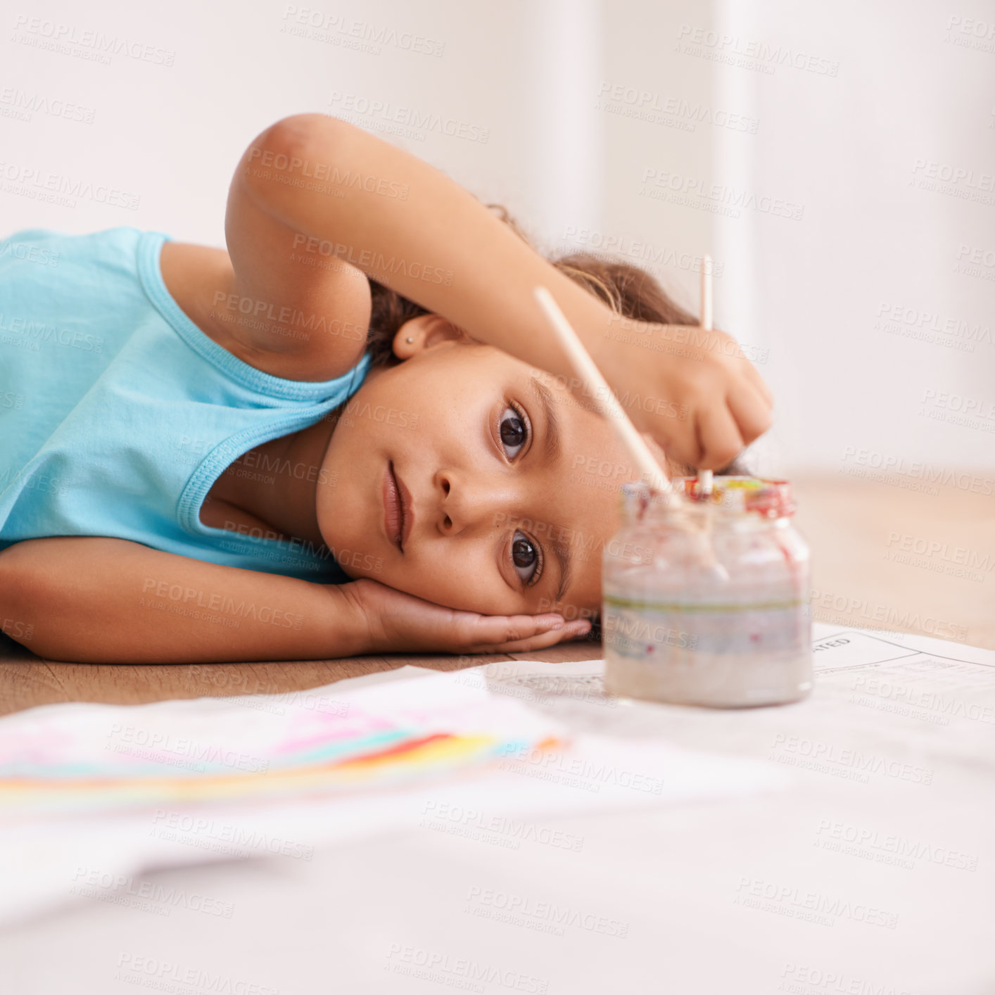 Buy stock photo Children, portrait and girl on a floor for painting, art or playing in her home with rainbow, paper or fun. Face, paintbrush or kid on the ground with water for for color splash, creative or drawing