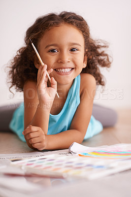 Buy stock photo Shot of a little girl painting a picture of a rainbow