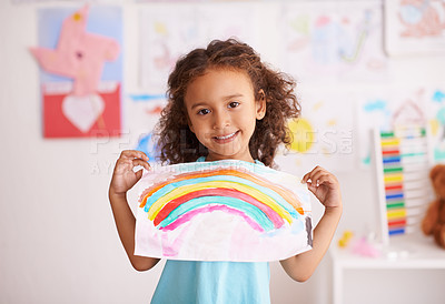 Buy stock photo Shot of a little girl holding up a picture she painted of a rainbow