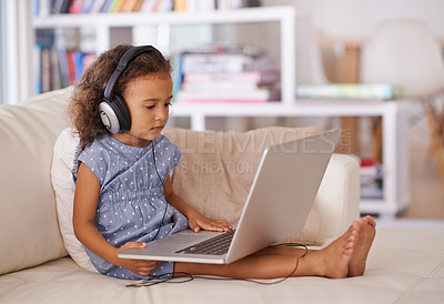 Buy stock photo Kindergarten, elearning and kid on laptop in home with online class, video and girl with headphones. Virtual, education and child with computer on sofa in house for development of language knowledge