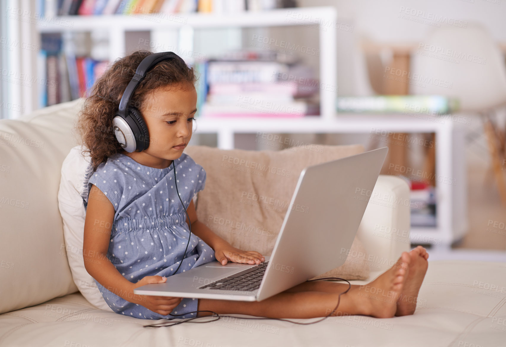 Buy stock photo Kindergarten, elearning and kid on laptop in home with online class, video and girl with headphones. Virtual, education and child with computer on sofa in house for development of language knowledge