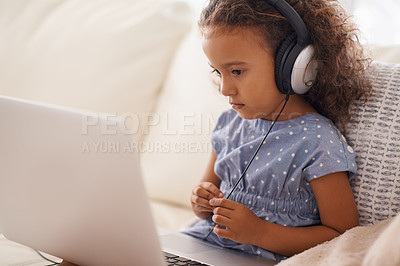 Buy stock photo Kindergarten, kid and elearning on laptop in home with online class, video and girl with headphones. Virtual, education and child with computer on sofa in house for development of language knowledge