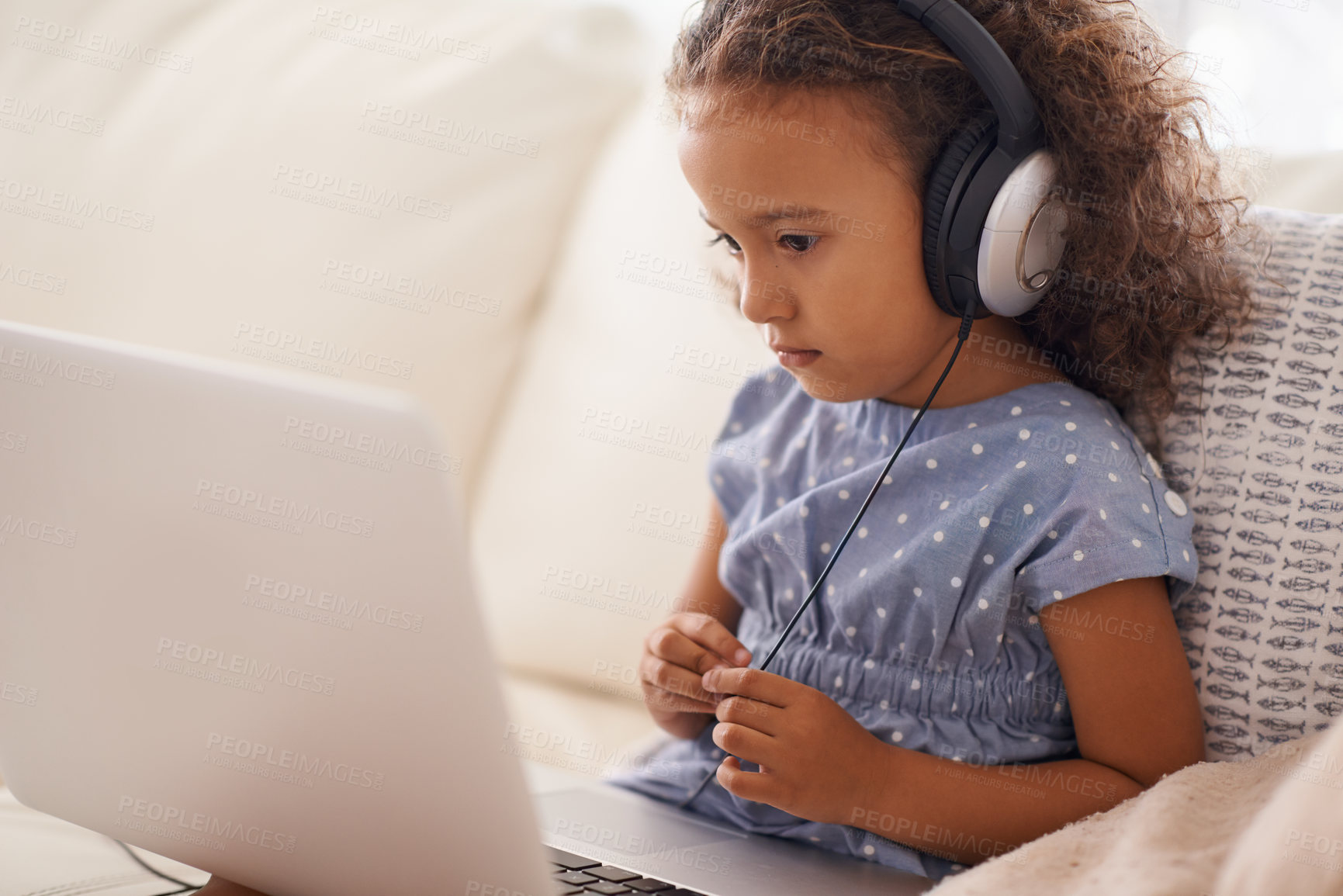 Buy stock photo Kindergarten, kid and elearning on laptop in home with online class, video and girl with headphones. Virtual, education and child with computer on sofa in house for development of language knowledge