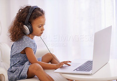 Buy stock photo Elearning, class and kid on laptop in home with online course, video and girl with headphones. Virtual, education and child click on computer in house for development of language or math knowledge