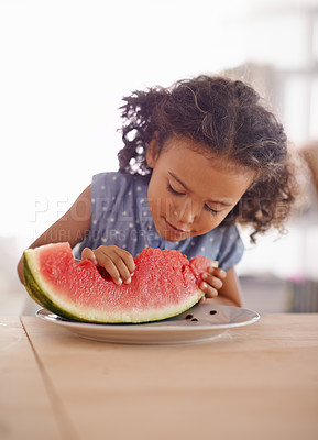 Buy stock photo Child, eating and hungry with watermelon in home, nutrition and healthy food on table in kitchen. Girl, organic fruit and happy for snack in summer on vacation, wellness and vitamins for development