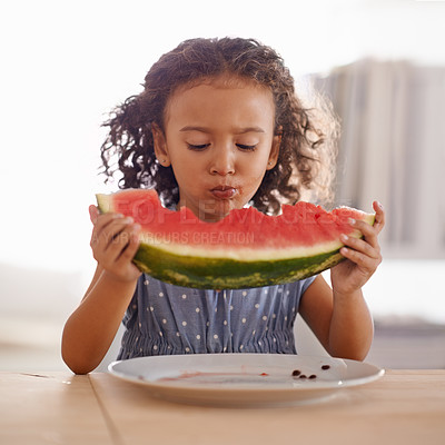 Buy stock photo Child, eating and happy with watermelon in home, nutrition and healthy food on table in kitchen. Girl, organic fruit and hungry for snack in summer on vacation, wellness and vitamins for development