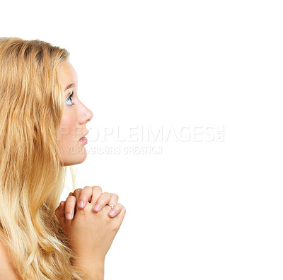 Buy stock photo Shot of an attractive young woman praying against a white background
