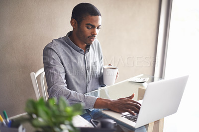 Buy stock photo Laptop, drinking coffee and black man in home office for business, remote work or typing email. Tea, computer and serious freelancer at desk for accounting, bookkeeping or calculation on internet