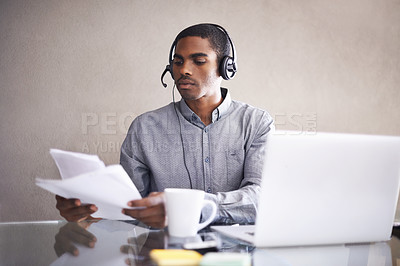 Buy stock photo Businessman, laptop and headphones with paperwork for call center, online advice or consulting at office. Black man, consultant or African employee with documents and computer for customer service