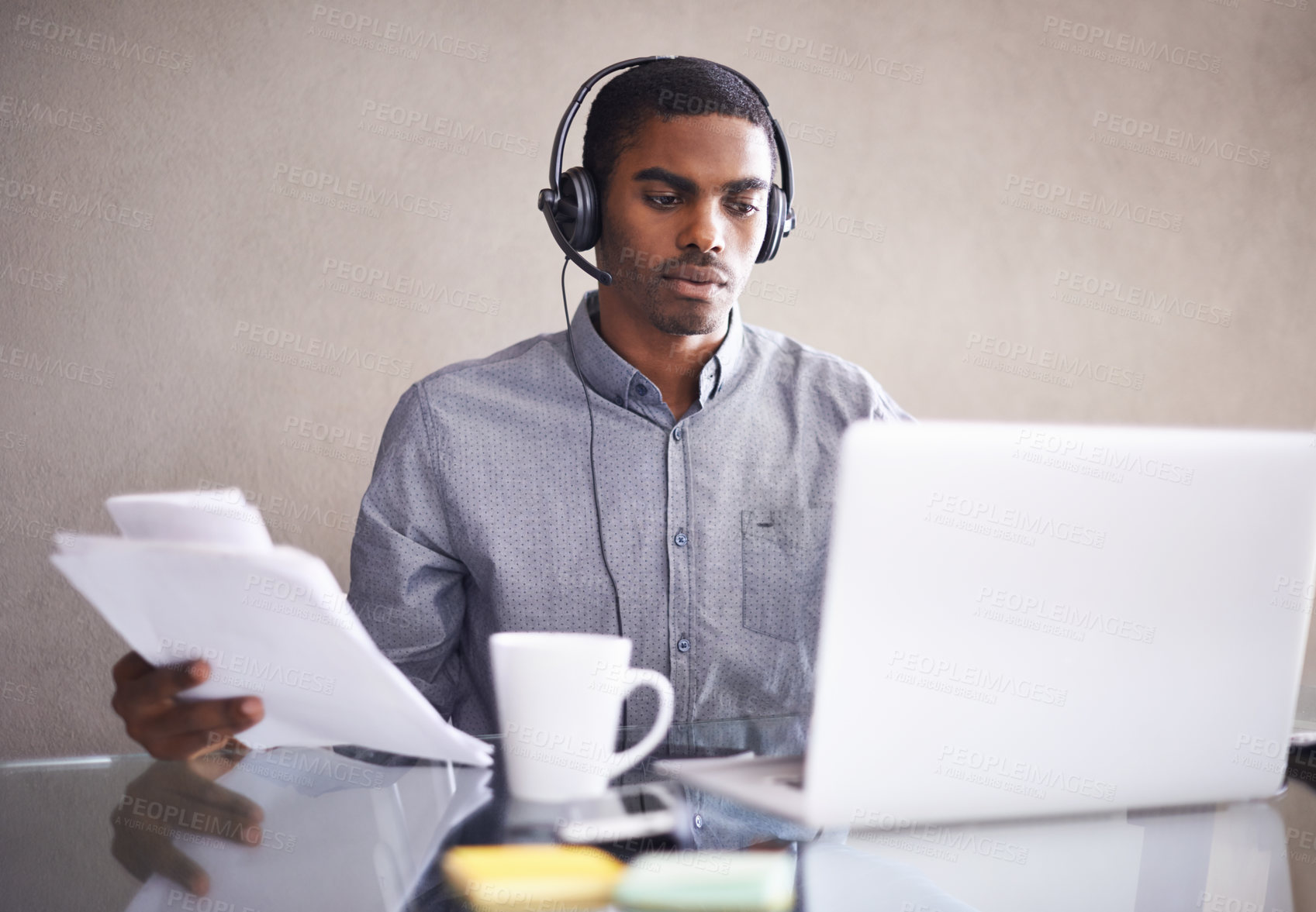 Buy stock photo Businessman, laptop and headphones with documents for call center, online advice or consulting at office. Black man, consultant or African employee with paperwork and computer for customer service