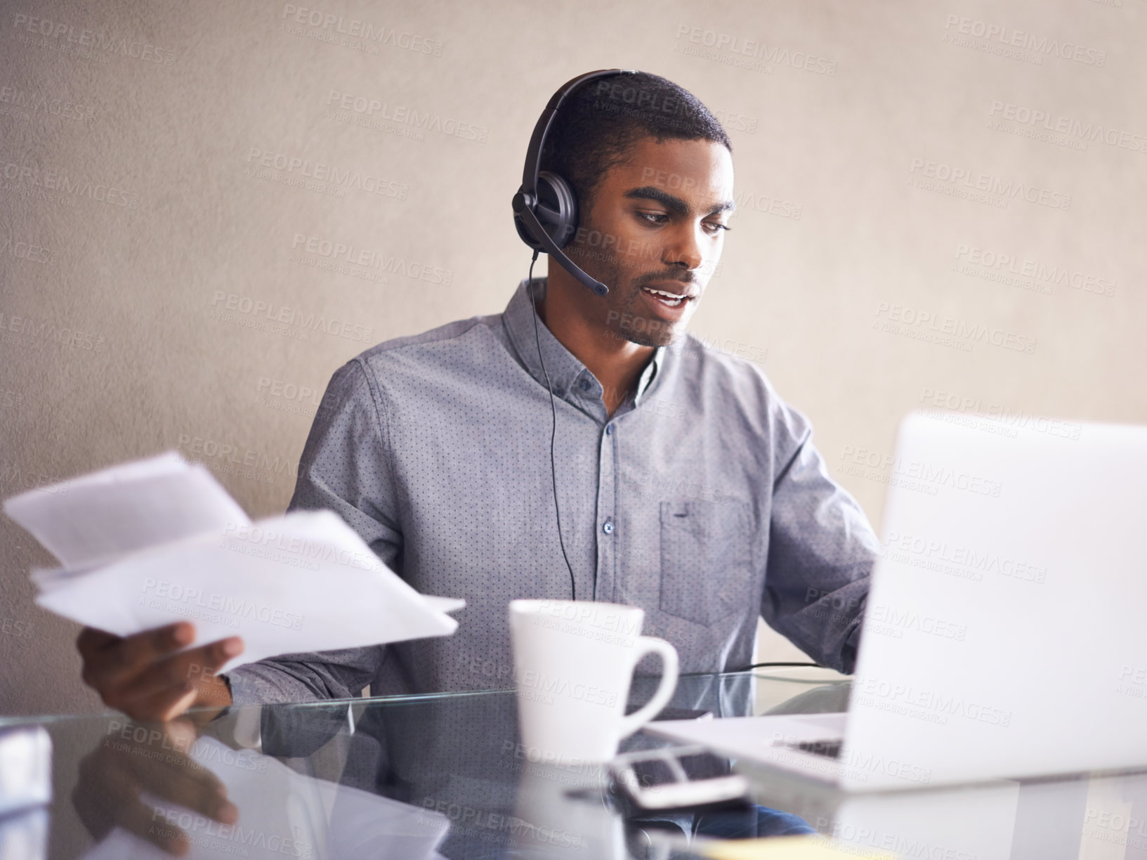 Buy stock photo Businessman, laptop and headphones with paperwork for consulting, online advice or call center at office. Black man, consultant or African employee with documents and computer for customer service