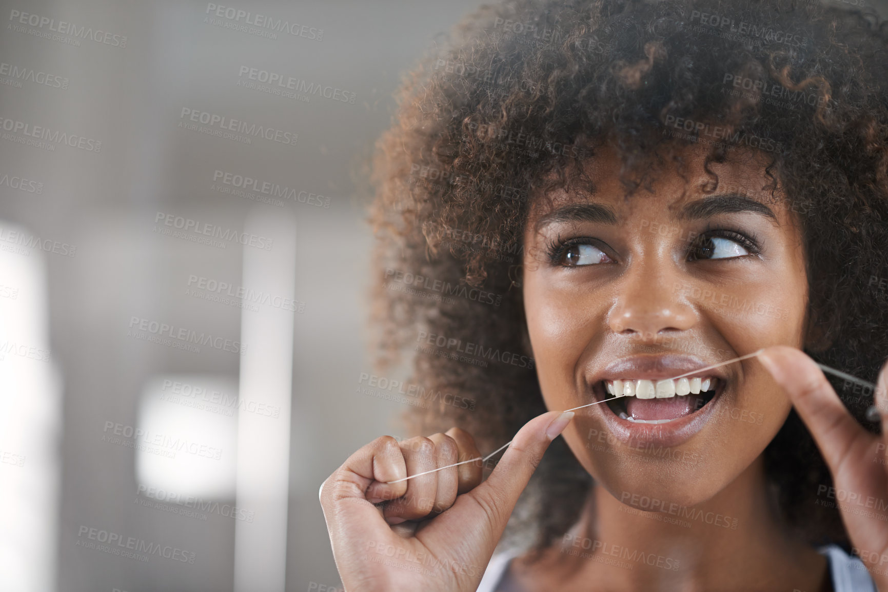 Buy stock photo Shot of a young woman flossing her teeth in the mirror