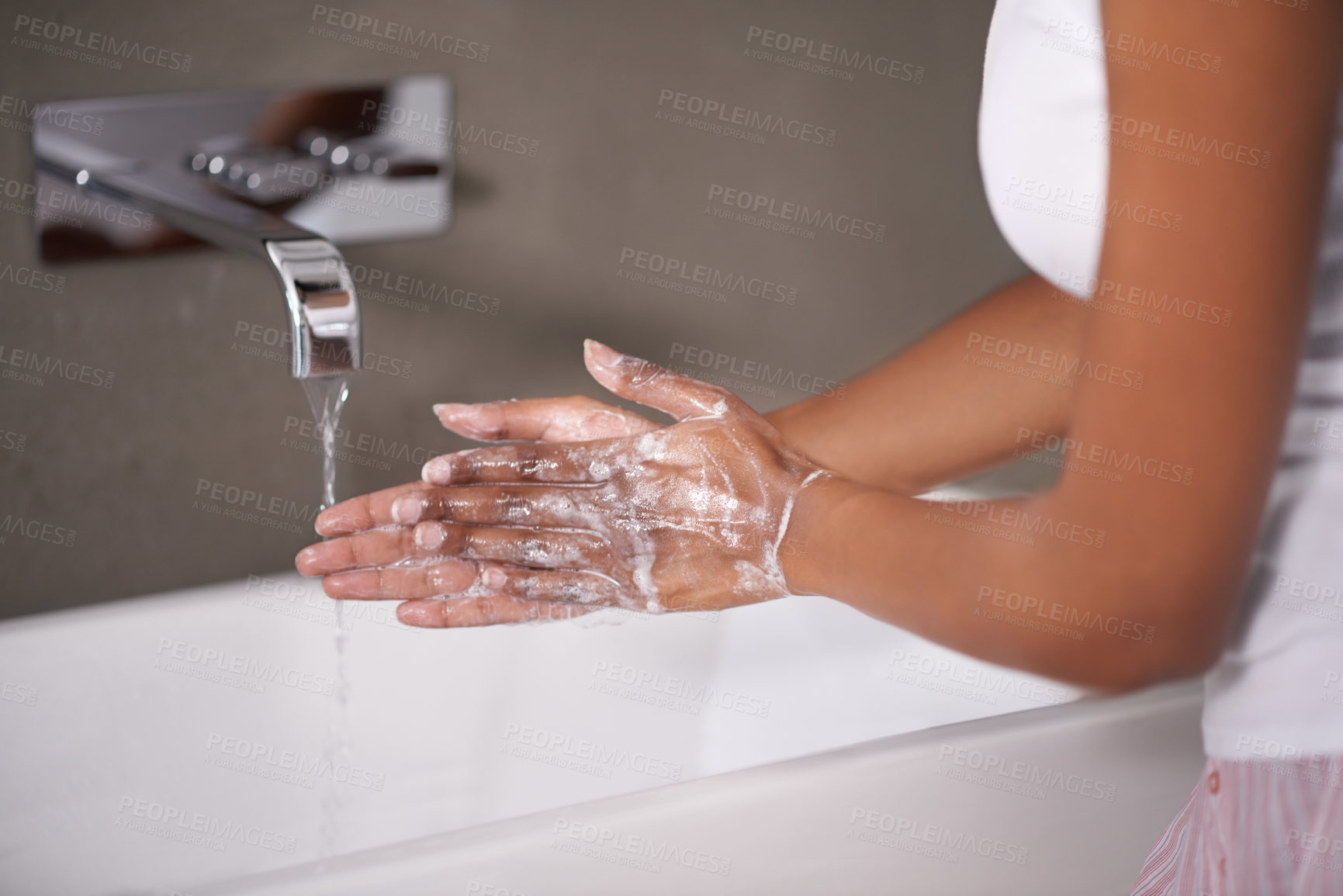Buy stock photo Hands, water and foam for cleaning with person in bathroom, hygiene and wellness for protection from germs. Bacteria, virus and disinfection at sink with soap, skincare and cosmetics in routine