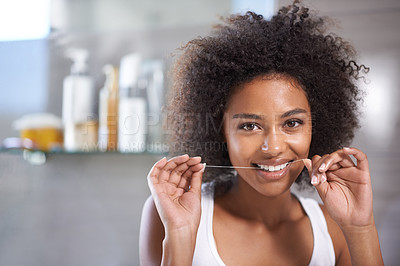 Buy stock photo Black woman, portrait and floss for teeth in bathroom, dental health and wellness for fresh breathe at home. String, thread and product for oral hygiene with morning routine and orthodontics