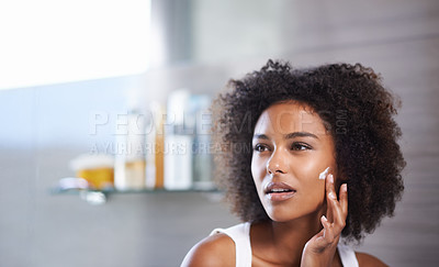 Buy stock photo African woman, skincare and facial cream with smile, wellness or afro in home bathroom for morning routine. Girl, person and serum with cosmetics, beauty or transformation with self care in apartment