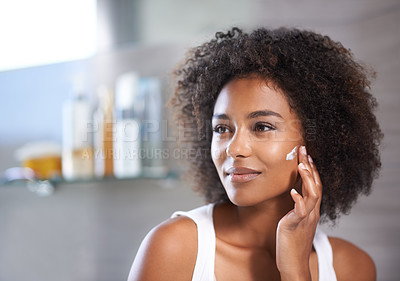 Buy stock photo Black woman, cream on face and skincare in bathroom for beauty at home, morning routine and antiaging treatment. Facial, mask with lotion or sunscreen, cosmetic care and moisturizing for healthy skin