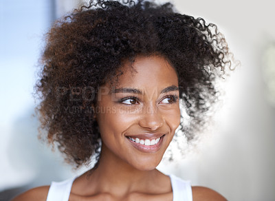 Buy stock photo Shot of an attractive young woman looking thoughtful in her home