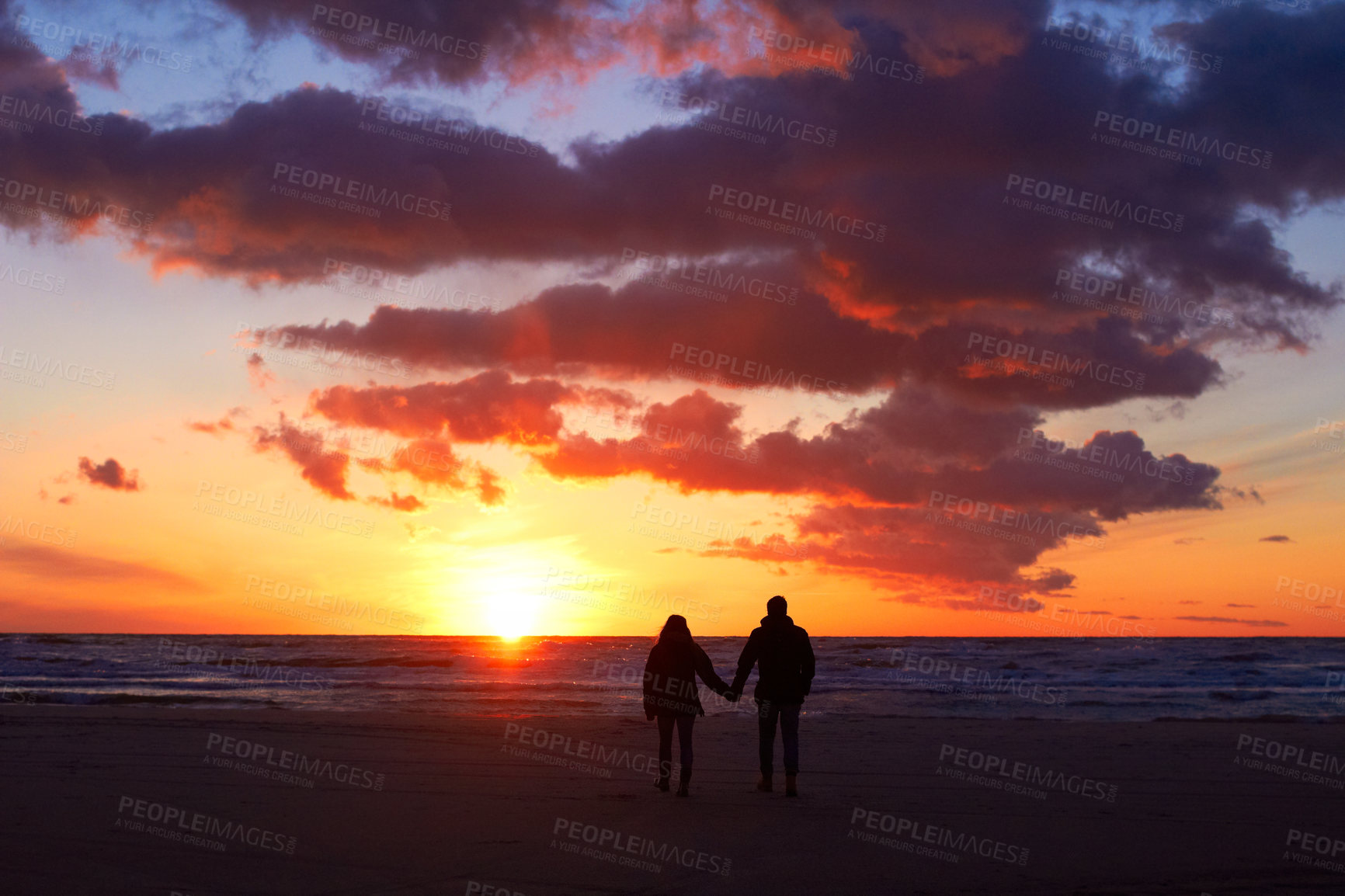 Buy stock photo Silhouette, couple holding hands at sunset and on beach walking together. Love or care, holiday or vacation and shadows of people on the seashore for embrace for romance date or honeymoon outdoor