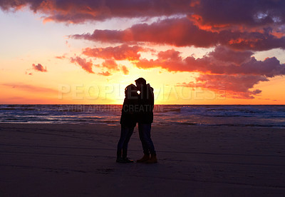 Buy stock photo Kiss, silhouette people together at sunset and on seaside together for honeymoon. Care or love, holiday and shadows of couple on the beach or sea for romantic date outdoor on summer vacation