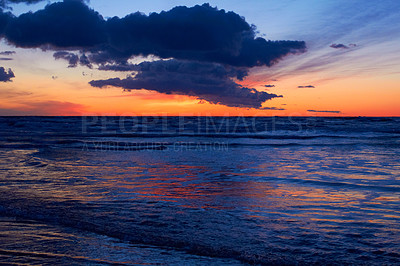 Buy stock photo Shot of a beautiful sunset over the beach