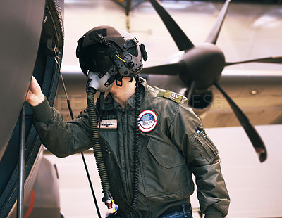 Buy stock photo Shot of a fighter pilot inspecting his aircraft