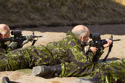 Buy stock photo Rearview shot of soldiers practicing sharpshooting