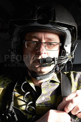 Buy stock photo Portrait of a pilot in his aircraft wearing a helmet with a communication device