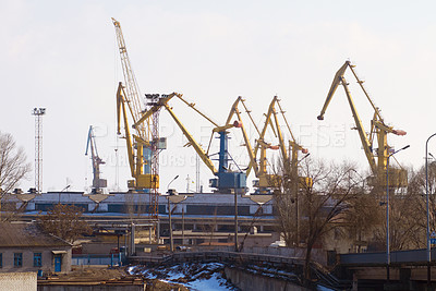 Buy stock photo Harbor, port and crane for shipping, outdoor and buildings for industry, manufacturing and supply chain. Urban shipyard, machine and equipment for trade, export and infrastructure for distribution