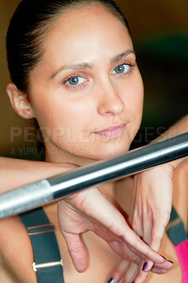 Buy stock photo Portrait of an attractive young woman posing with a barbell at the gym