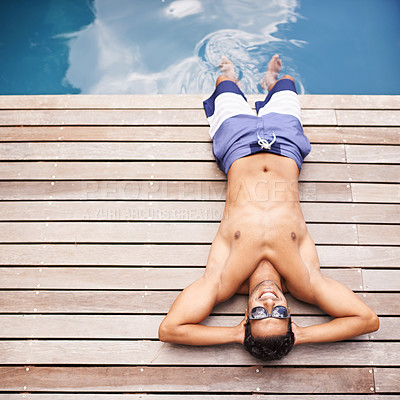Buy stock photo Pool, deck and man relax in summer with happiness at hotel, resort or above villa in Miami for vacation. Calm, holiday and person lying in sunshine at poolside with freedom and peace in Florida