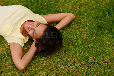 Buy stock photo Happy woman relax on park grass, garden and nature, freedom or rest on summer lawn with mockup. Above of young girl lying on green field outdoor in sunshine for calm, peace and mental health wellness