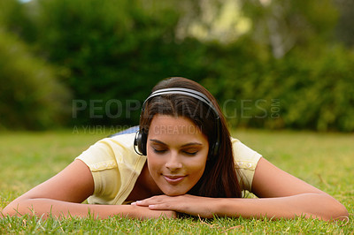 Buy stock photo Park, relax and woman on grass with headphones enjoying weekend, summer holiday and vacation. Peace, happiness and latin girl listening to music, audio and song in nature, outdoors and laying on lawn