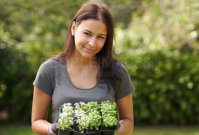 Buy stock photo Woman, flowers and gardening with portrait in nature, ecology and sustainability with environment. Landscaping, gardener with plant and eco friendly for growth, greenery and botanical outdoor
