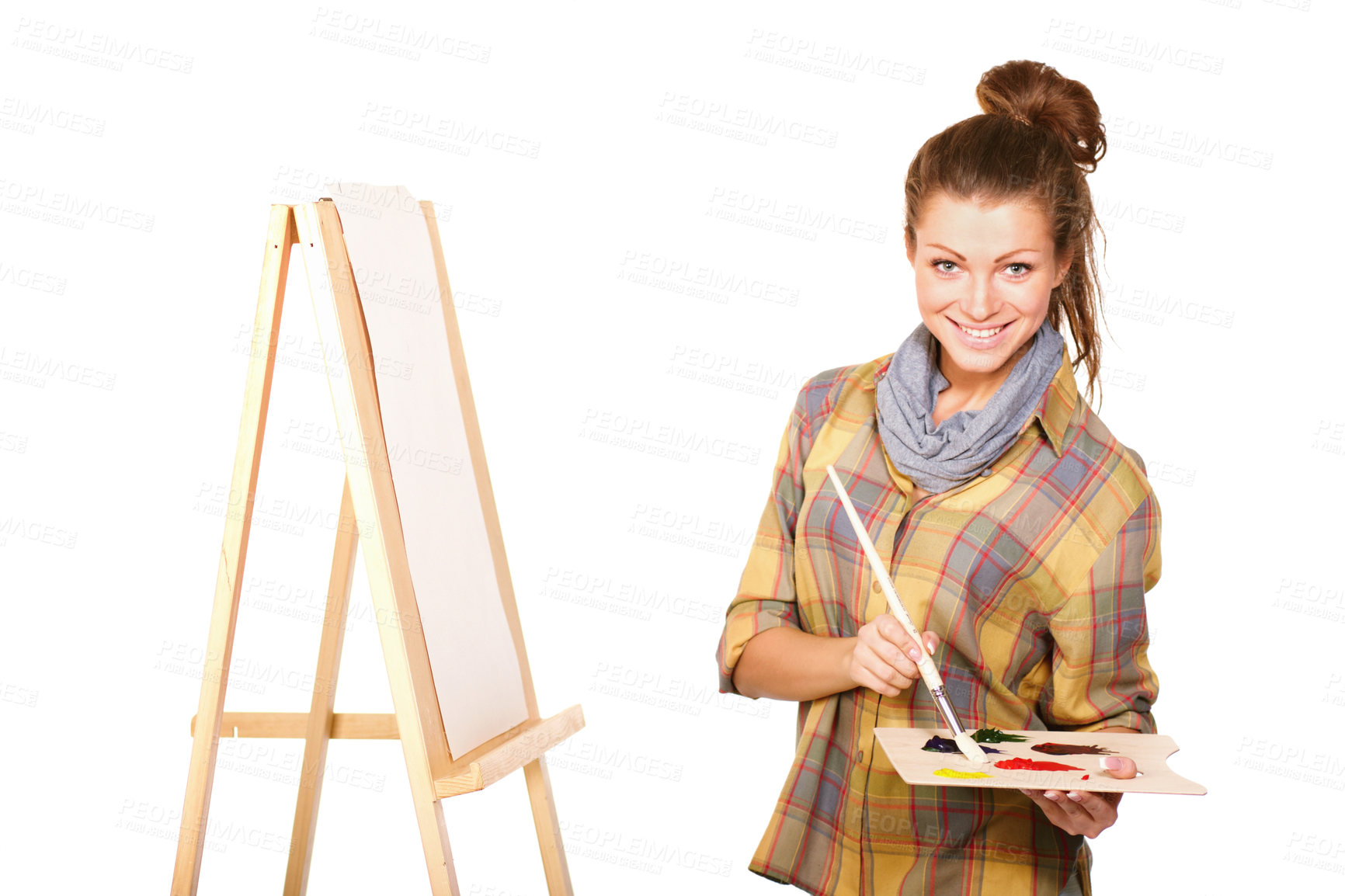 Buy stock photo Studio shot of a young woman holding a palette and brush and standing with an easel